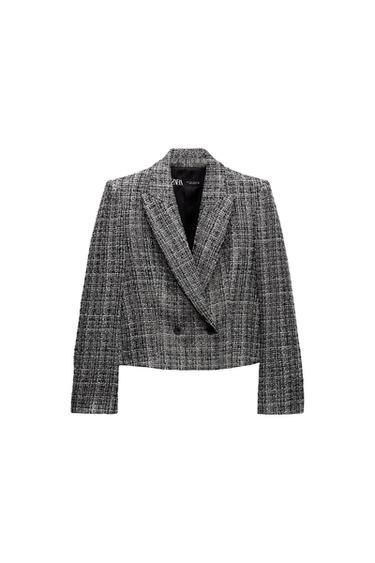 Front view of a gray cropped jacket with wide lapels and double-breasted closure.