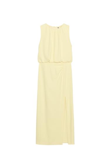 Front view of a sleeveless yellow dress with pleats and a side slit.