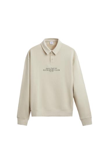 Beige sweatshirt with a polo neck and "Superior People Style ELITE SPORT CLUB EST. 1975" text on the chest.