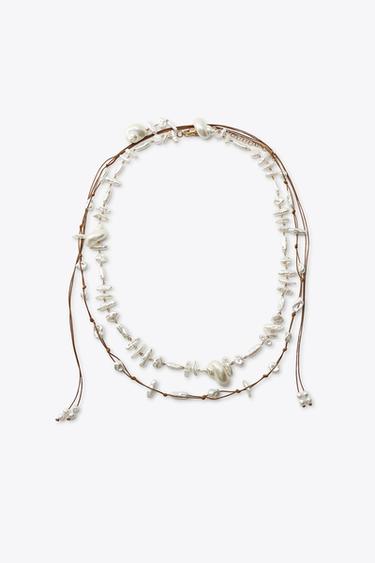 PACK 2 CINTURONES PERLAS CONCHAS - de Zara