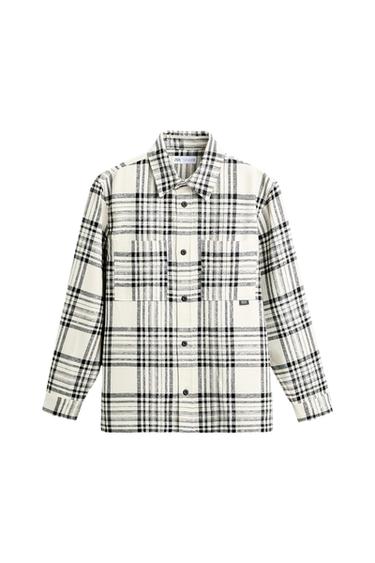 Front view of a black and white plaid shirt with front pockets and visible buttons.