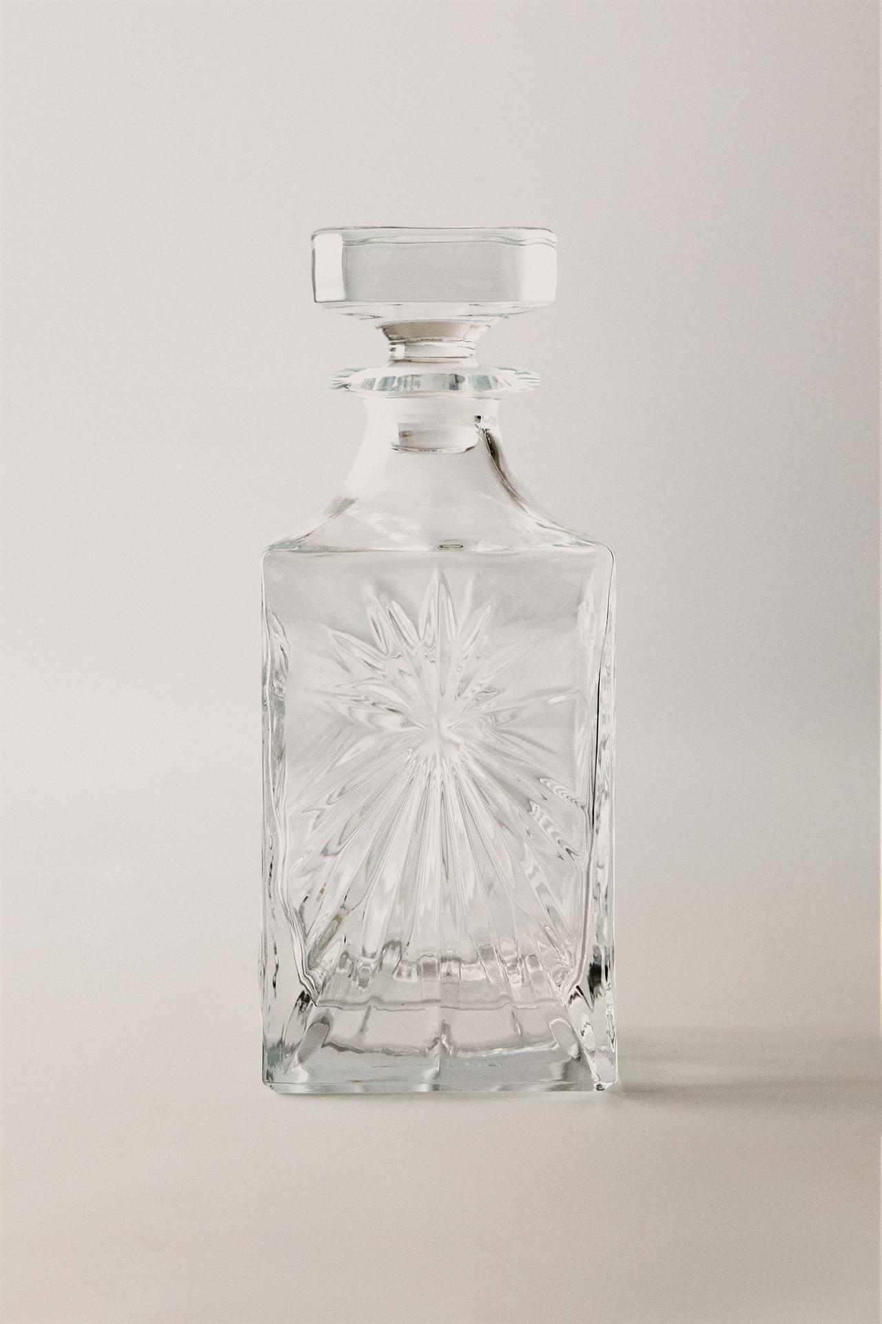 CRYSTALLINE BOTTLE WITH RAISED DESIGN — Transparent