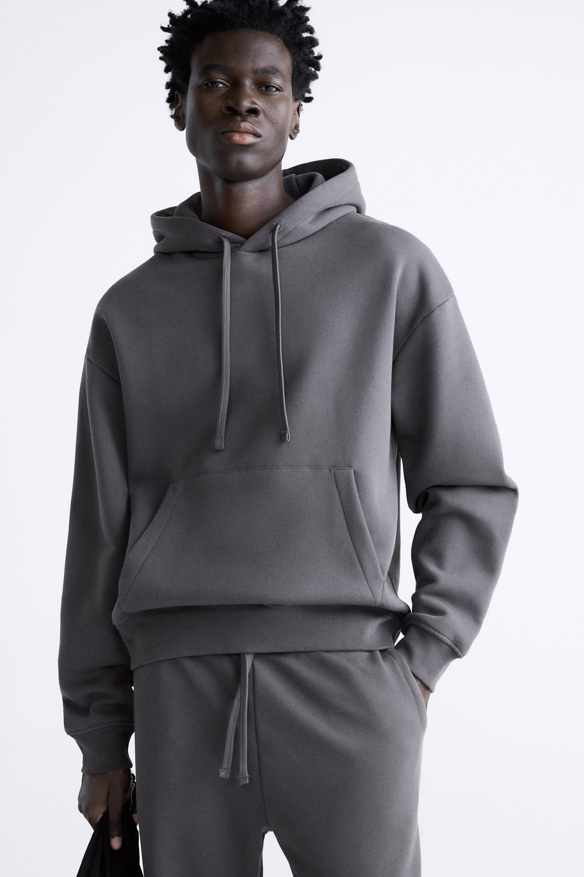 Grey sweatsuit. Hoodie with logo in the middle and matching sweatpants