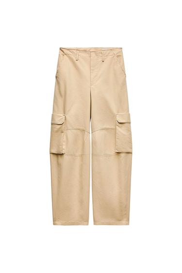 Front view of beige cargo pants with side flap pockets.