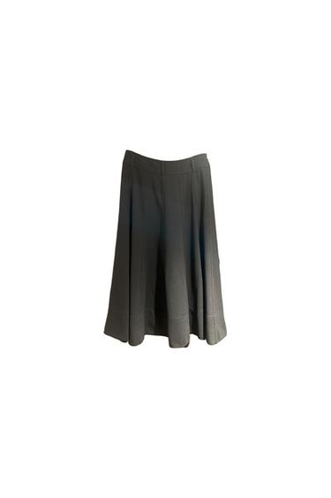 Black pleated midi skirt on a white background.