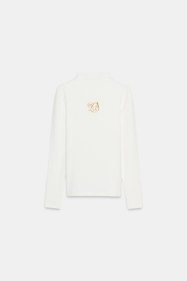 تيشرت ببروش وياقة بيركينز - أبيض مكسور الخاص بـ Zara