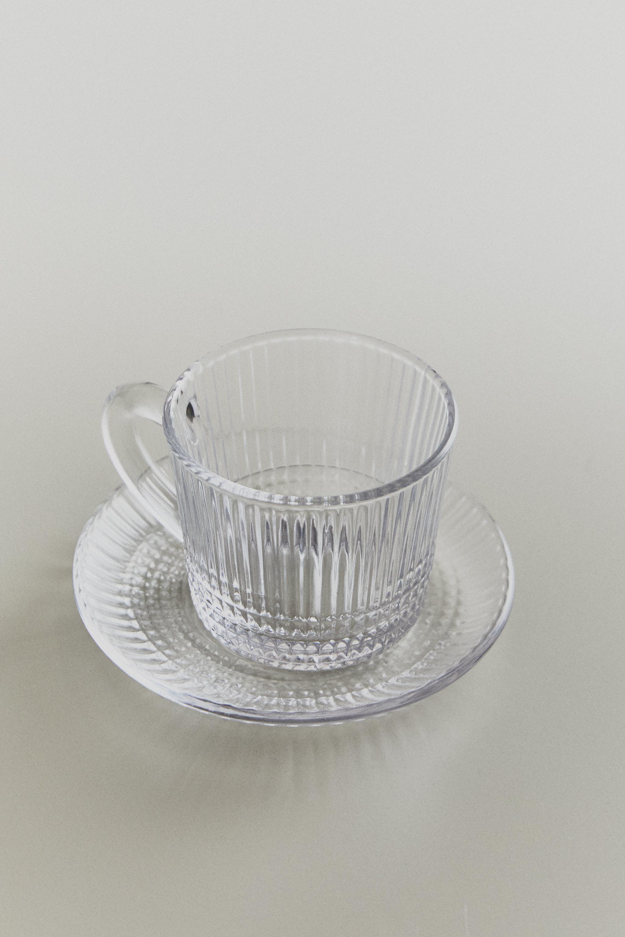 GLASS COFFEE CUP WITH SAUCER AND RAISED GEOMETRIC DESIGN. — Transparent