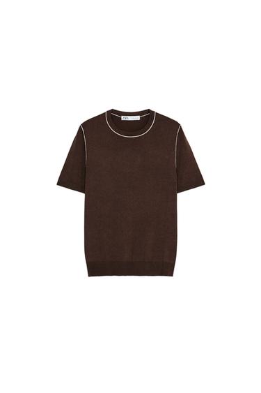 Front view of brown sweater with white trim on crew neck