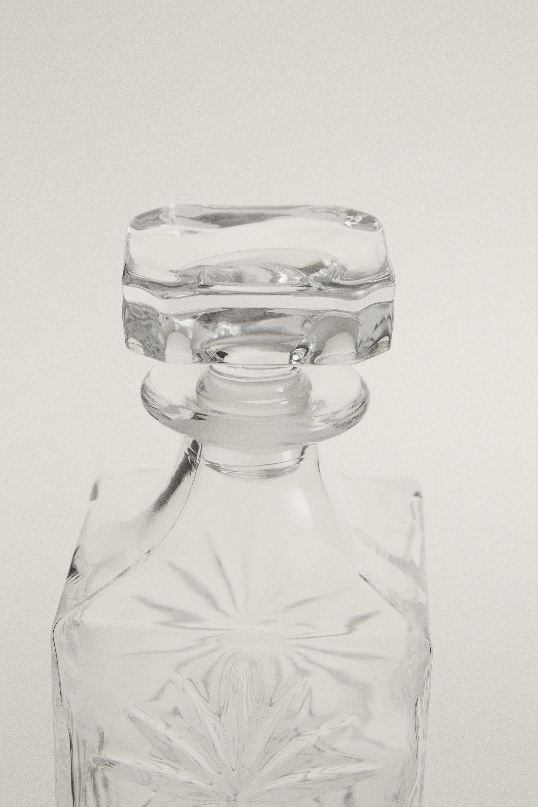 CRYSTALLINE BOTTLE WITH RAISED DESIGN — Transparent
