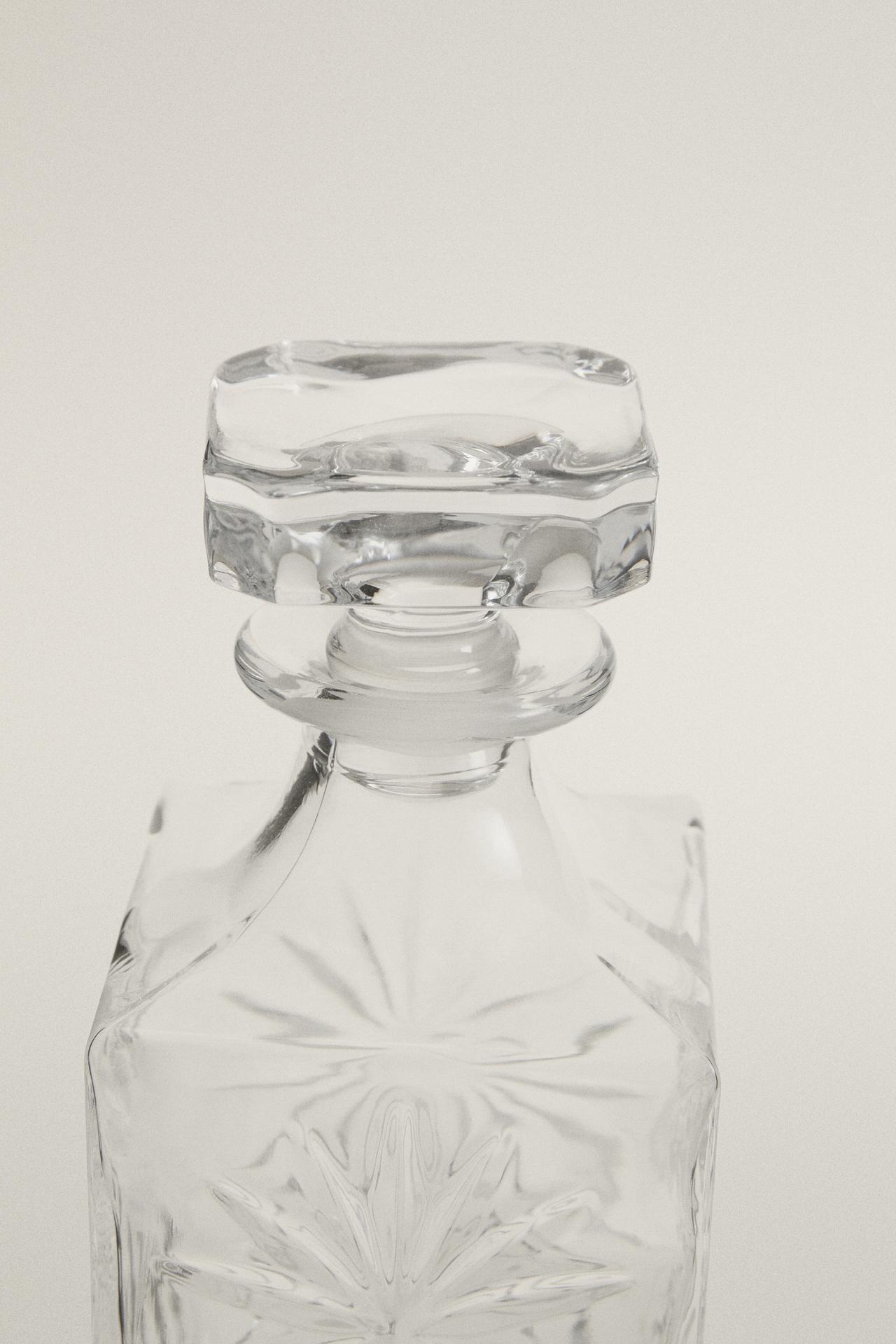 CRYSTALLINE BOTTLE WITH RAISED DESIGN — Transparent