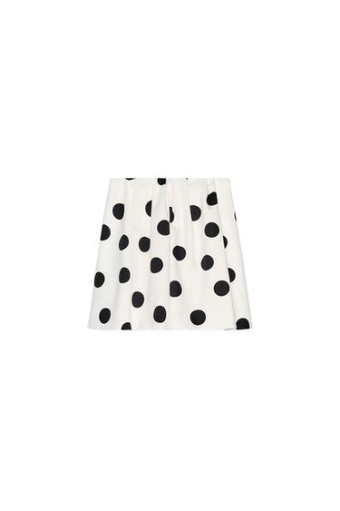 Front view of a white skirt with a black polka dot print.