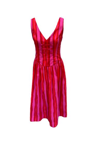 Pink and red vertical striped sleeveless dress. Features a V-neckline, strap detail on the chest and a flared skirt.