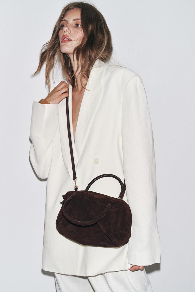 White blazer suit and dark brown handbag