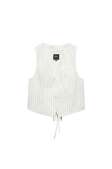 White waistcoat with thin vertical stripes and front buttons. Visible label with the text "ZARA". White background.