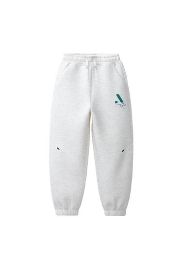 ŠPORTNE HLAČE Z LOGOTIPOM IZ NEOPRENA - Lisasto siva od Zare