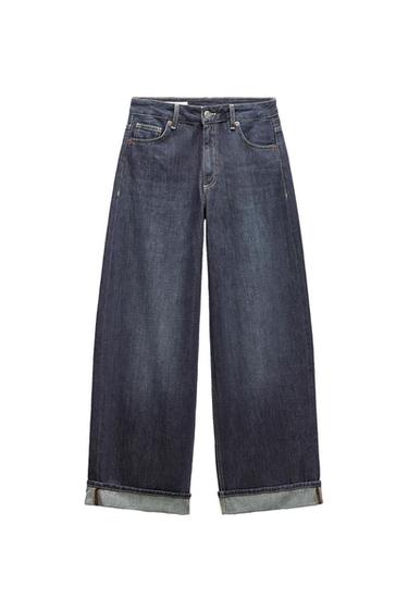 Dark blue wide-leg denim jeans with a turn-up hem, five pockets, and a button and zip fly.