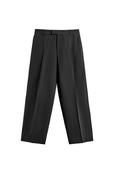 Front view of black trousers with pleats, straight leg, and belt loops.