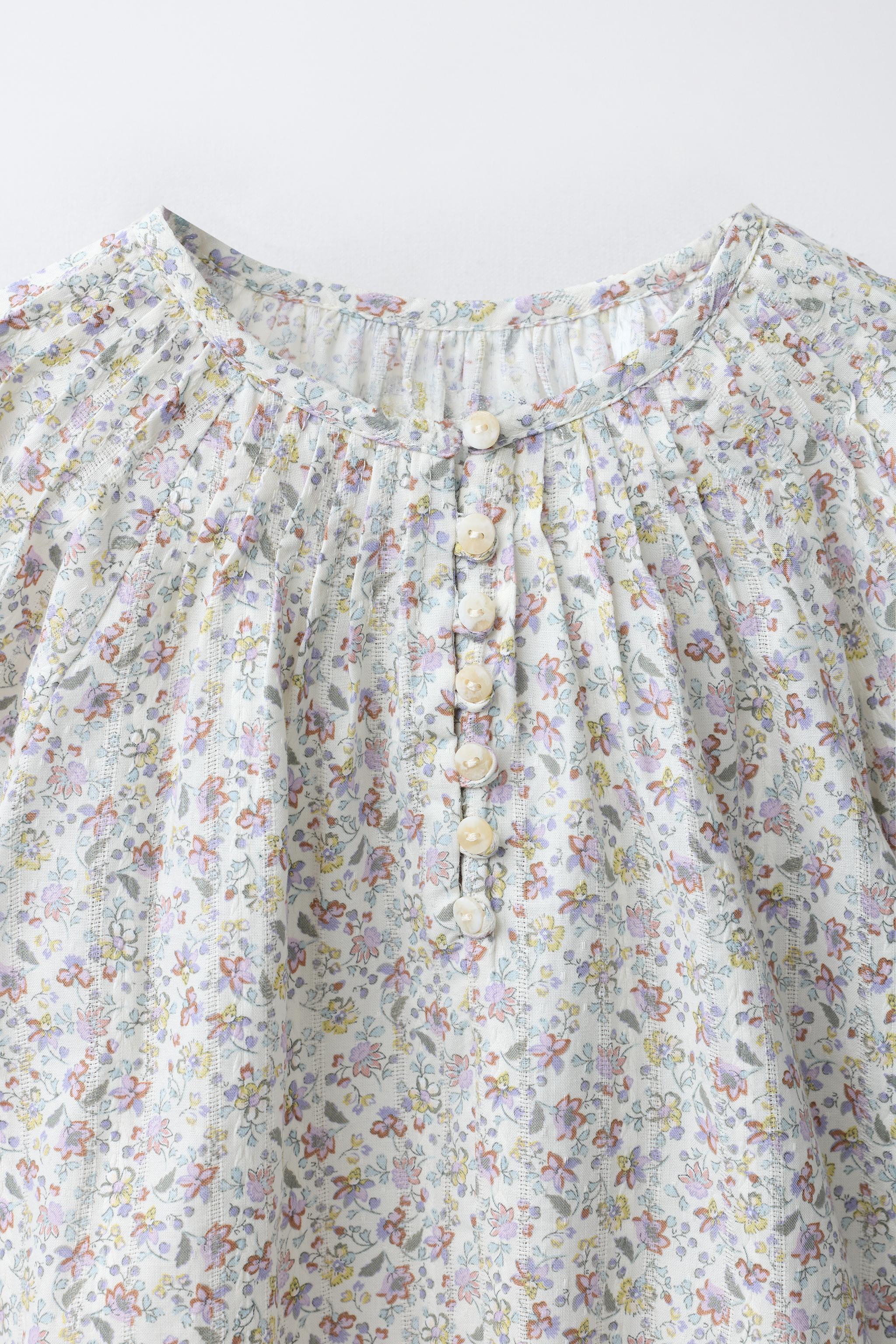 BLOUSE À PLIS NERVURÉS ET FLEURS