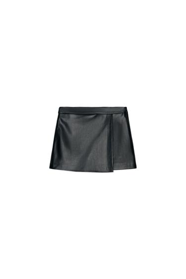 Front view of a black, high-waisted, short-cut, wrap culotte skirt with a concealed side zip.
