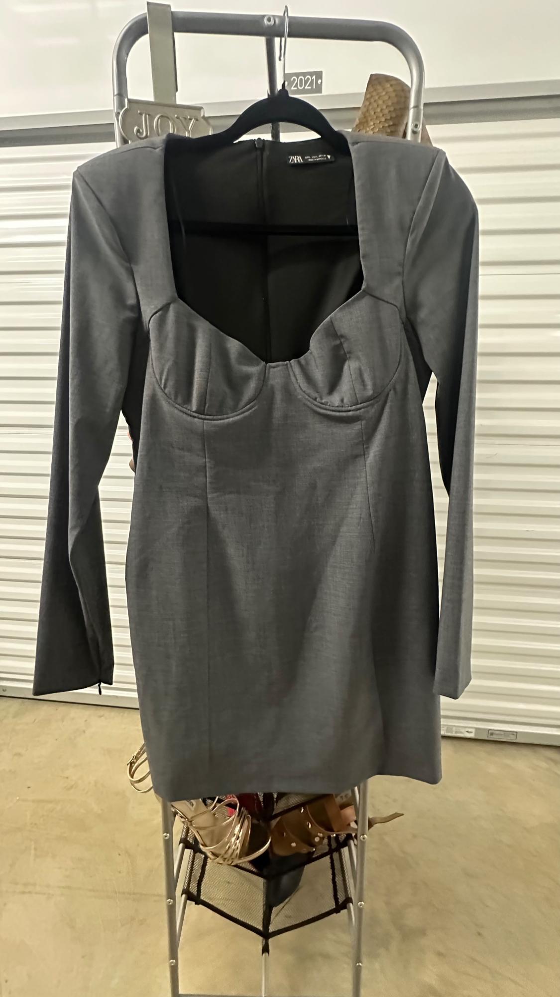 Front view of a grey dress with a square neckline and long sleeves.