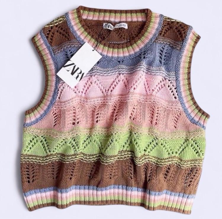 Multicoloured knitted waistcoat with geometric patterns in brown, blue, pink, and green tones. Visible label with text "ZARA".