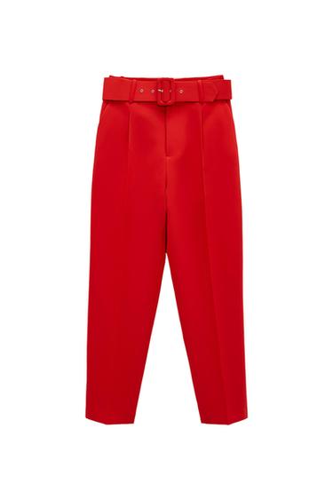 Red trousers with pleats and a matching belt with a buckle on a white background.