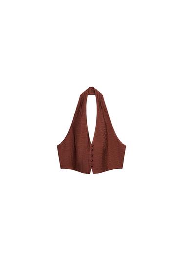 Front view of a dark terracotta halter crop top with a V-neck, open back, and front button fastening.