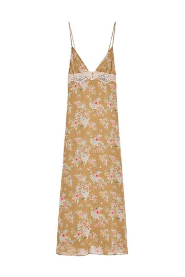 Front view of a khaki midi dress with floral print, V-neck, thin straps, lace detail on the chest and covered buttons.