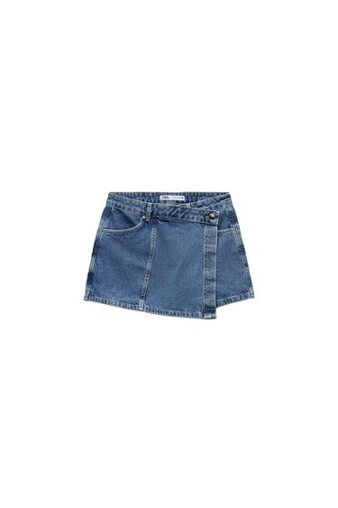 Front view of blue denim skort with side pockets and button closure.