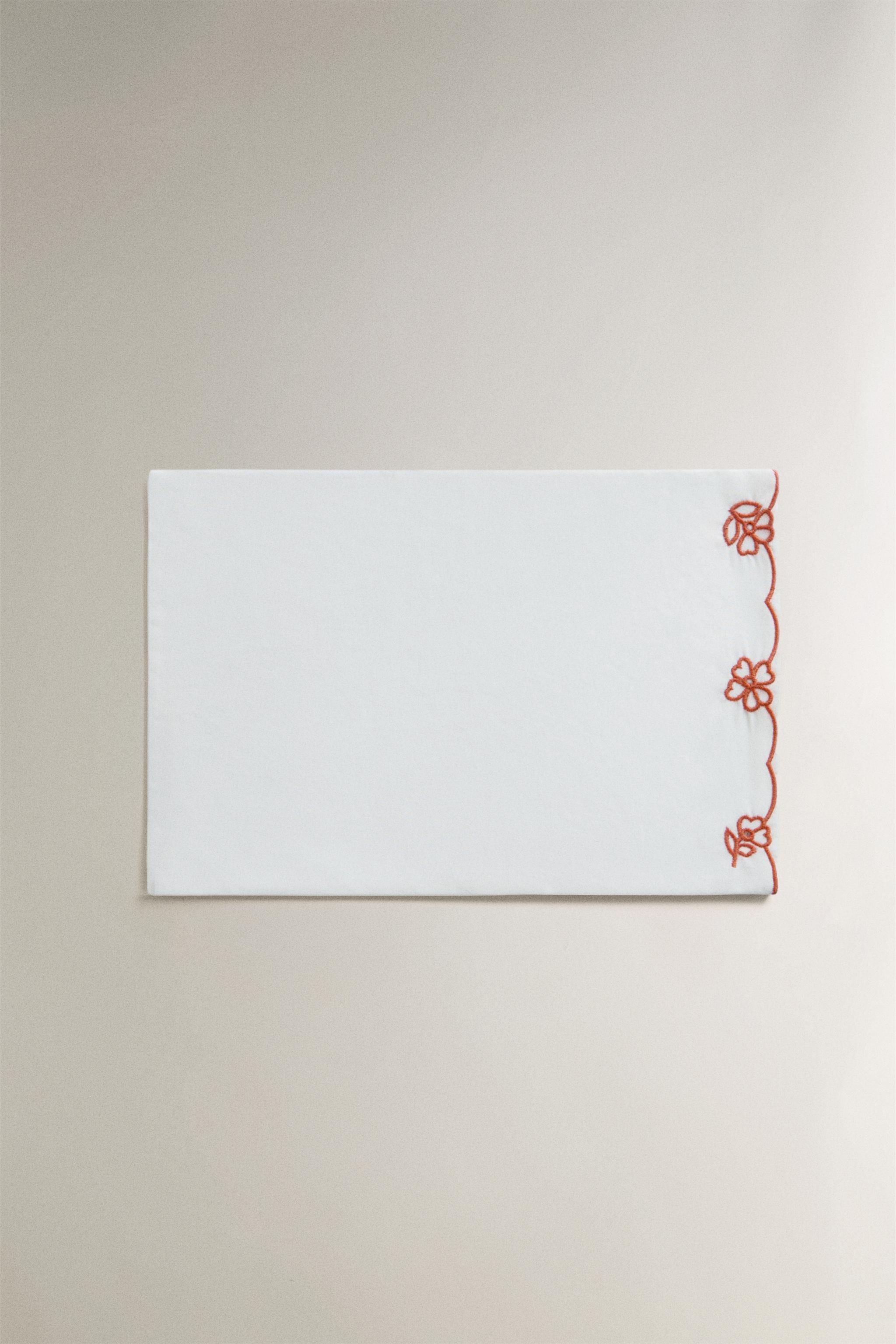 EMBROIDERED FLOWERS CRIB FLAT SHEET AND PILLOWCASE SET — Reddish