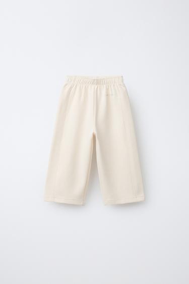 WIDE-LEG INTERLOCK TROUSERS WITH RAISED SLOGAN - Mid-ecru by Zara