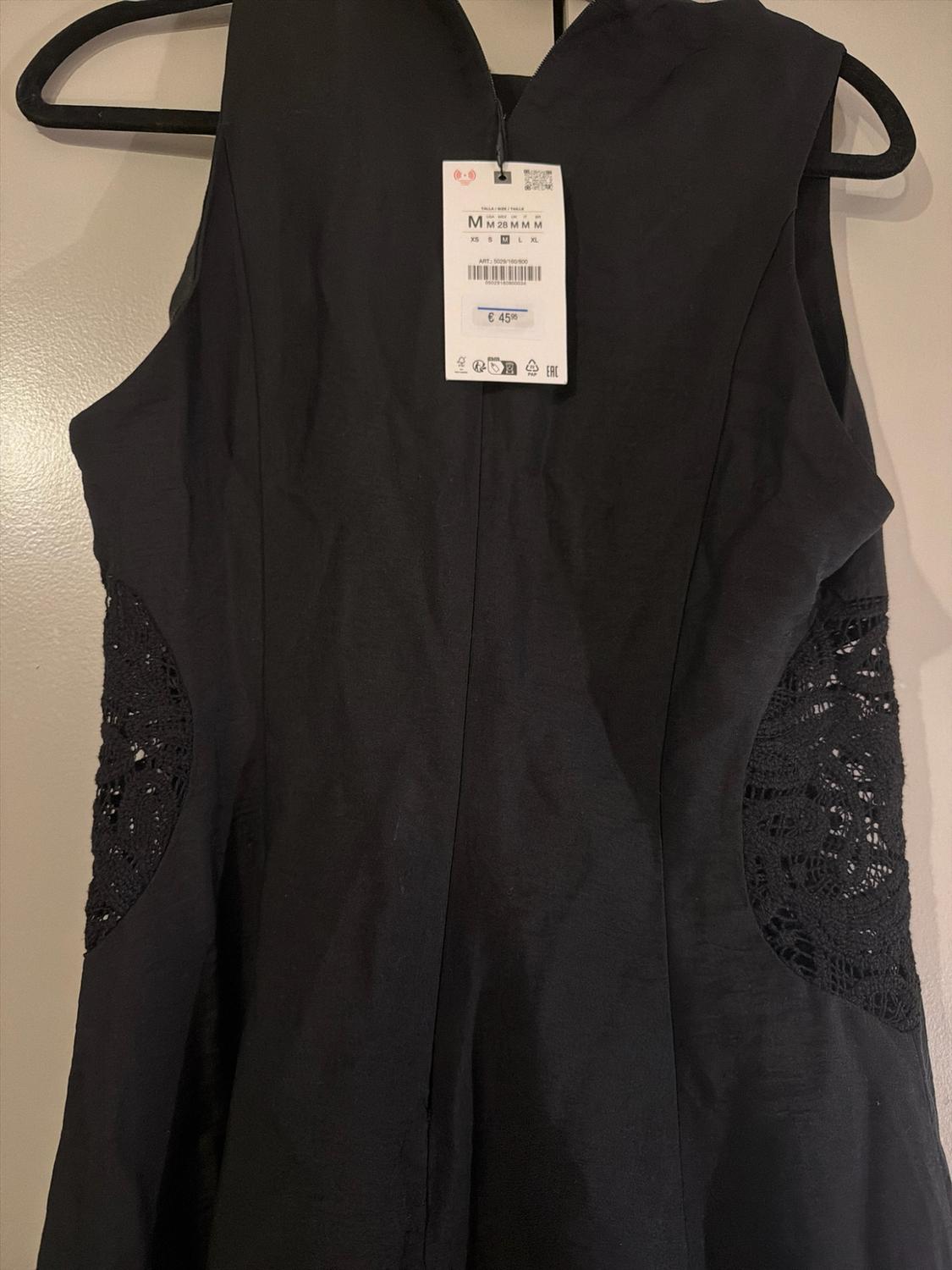 Sleeveless black dress with lace panels. Label: M M 28 M M M XS S M L XL ART: 5029/160/800 €45.95