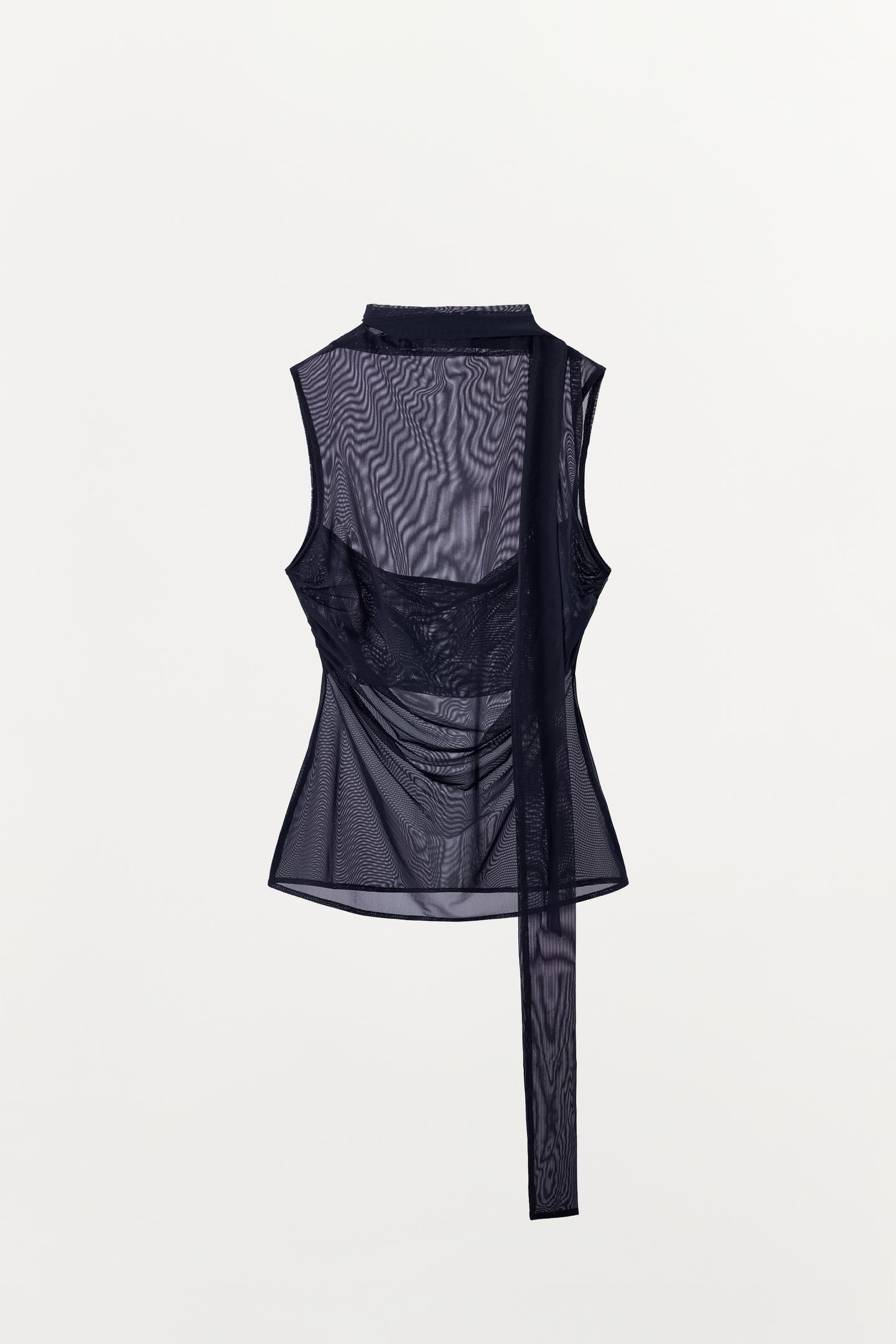 Rear view of a semi-sheer blue top with a draped neckline and sleeveless design. Features side ruching and foulard-style fabric.