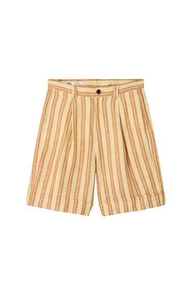 Front view of beige and brown vertical striped shorts with side pockets and button waist.