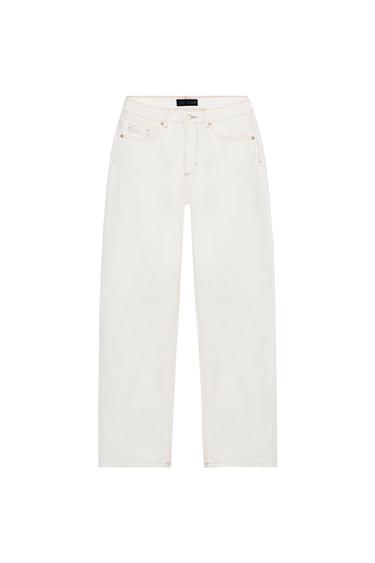 Front view of high-waisted, straight-leg white jeans. Five pockets and front zip and button fastening.