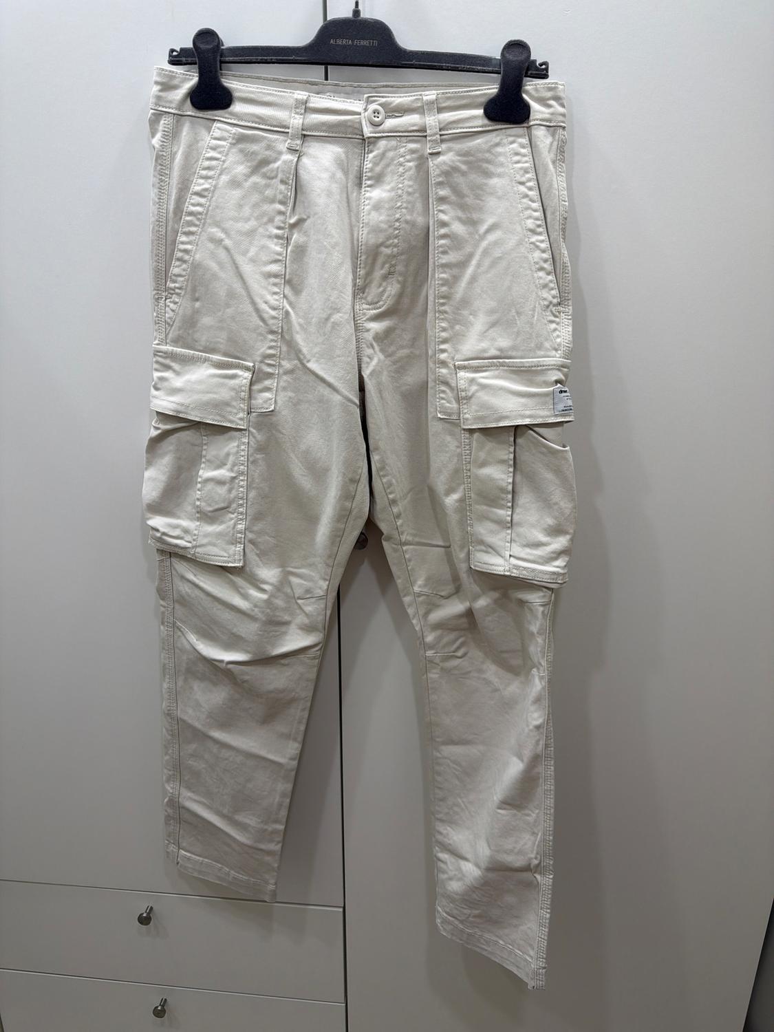 Beige cargo trousers hanging on a black hanger with the 'Alberta Ferretti' brand visible against a white background.