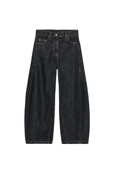 Front view of mid-rise black jeans with five pockets, contrasting topstitching, and a front zip and button closure.