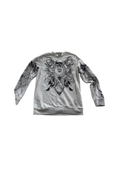 Gray long-sleeve sweatshirt with a black-and-white graphic print on the chest and sleeves, featuring a skull, a crest, and Gothic motifs.