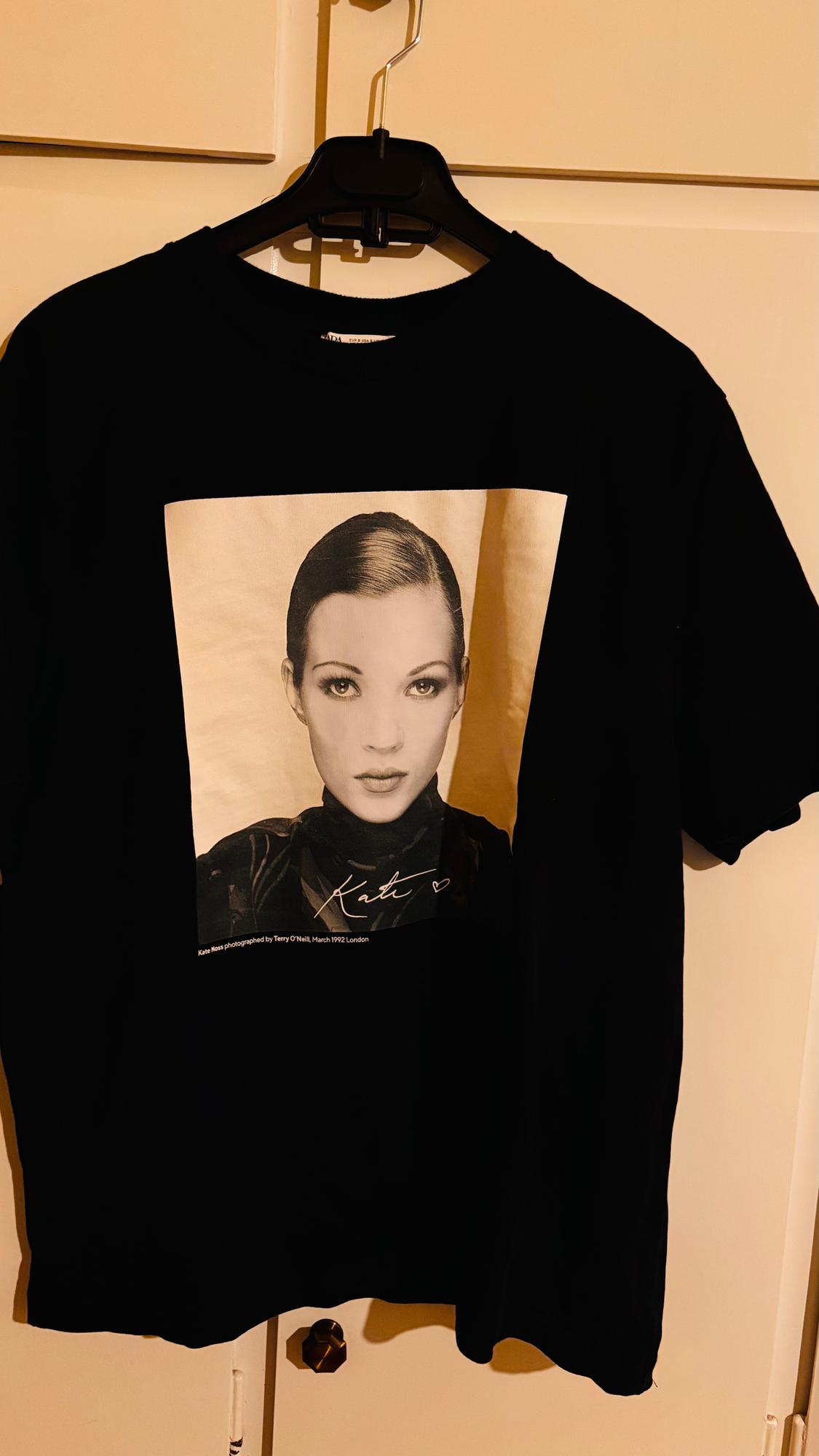 Black t-shirt hanging with a black and white photo of a woman. Text: "Kate" and "Kate Moss photographed by Terry O'Neill, March 1992 London".
