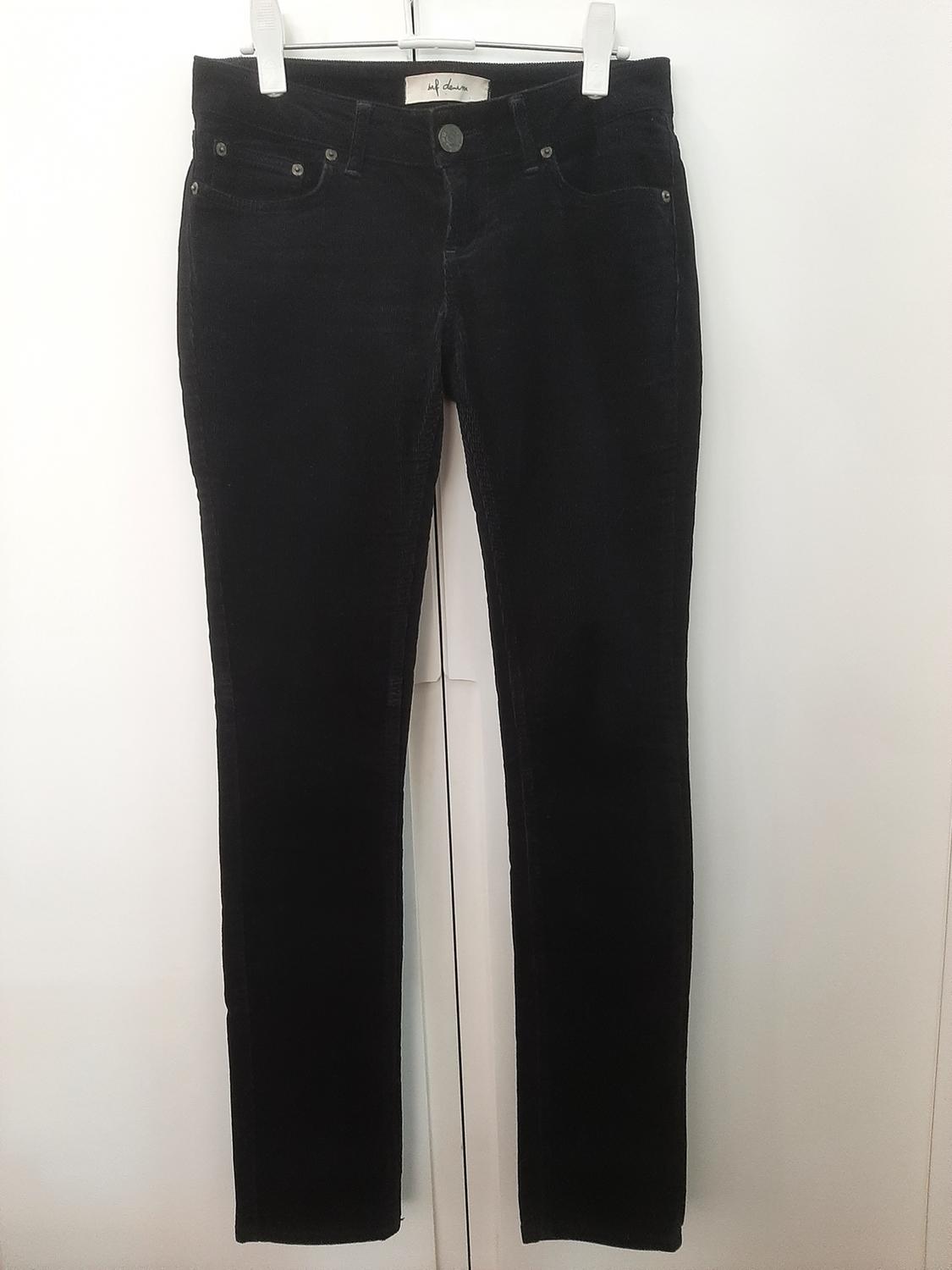 Front view of black trousers with side pockets and a visible button.
