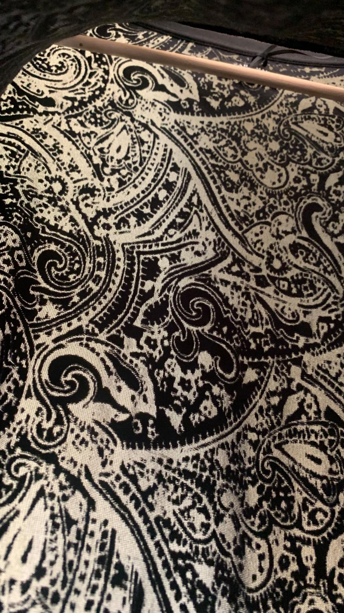 Detail of paisley print in black and cream tones.