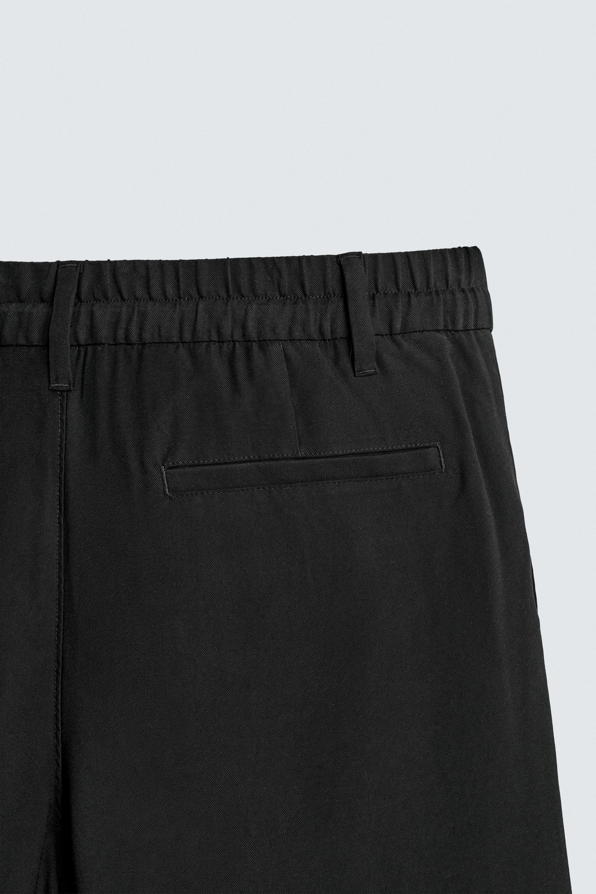 FLOWY RELAXED FIT PLEATED PANTS