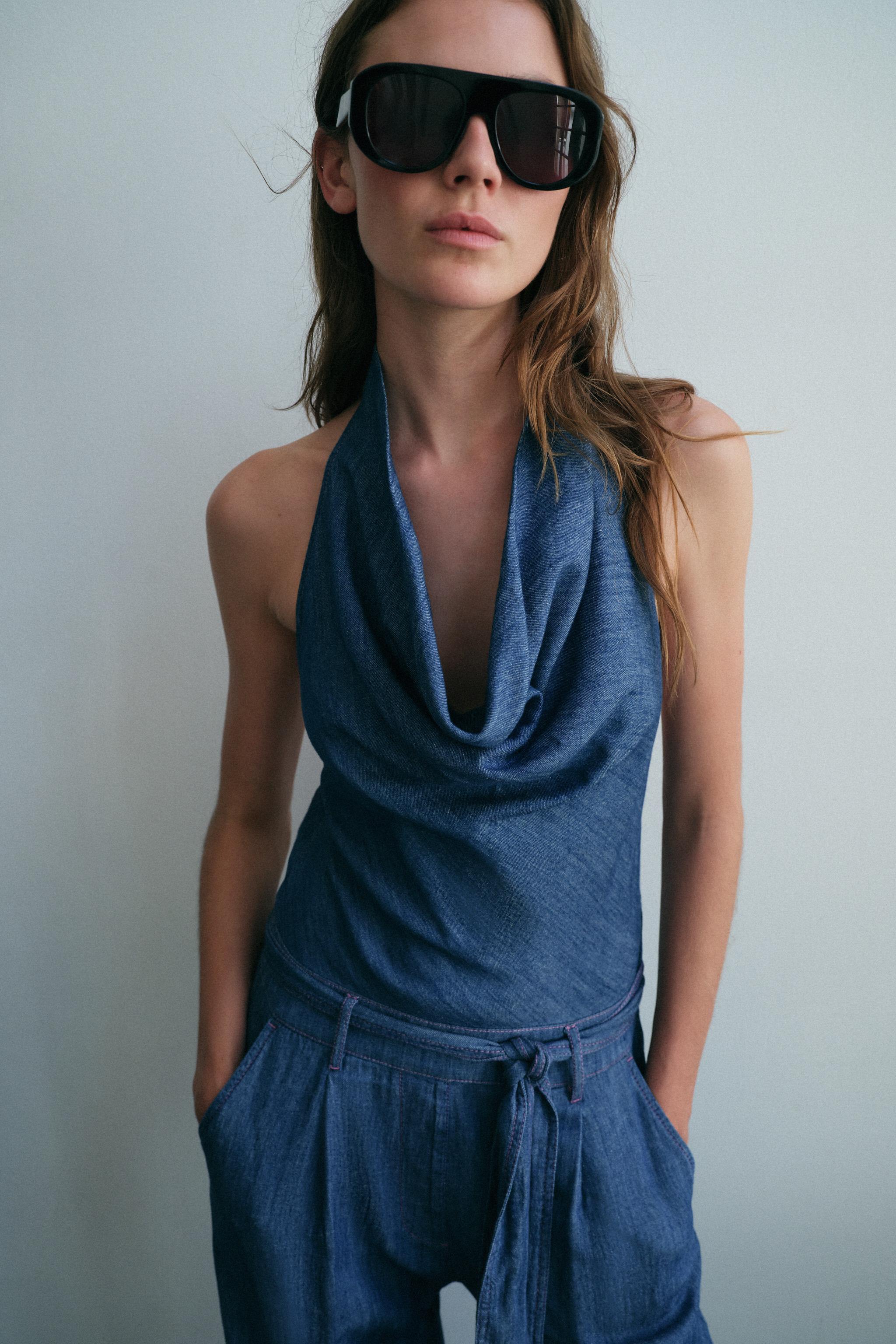 OPEN BACK BELTED HALTER JUMPSUIT — Indigo