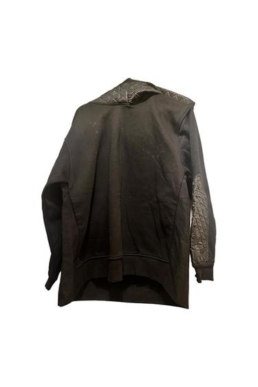 Black hooded sweatshirt with quilted detailing on the elbows and inside the hood, viewed from behind on a white background.