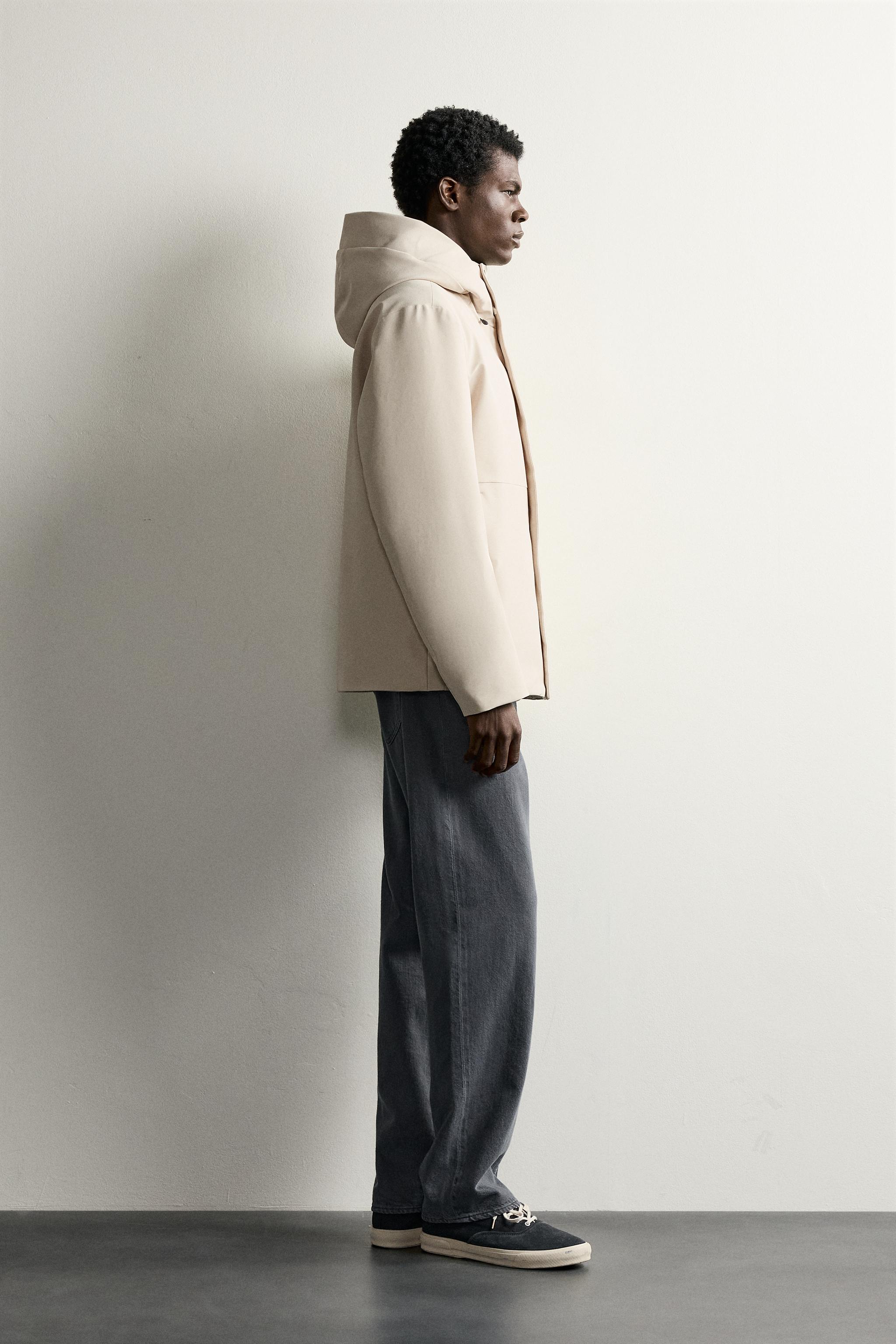 BLOUSON TECHNIQUE À CAPUCHE DÉPERLANT