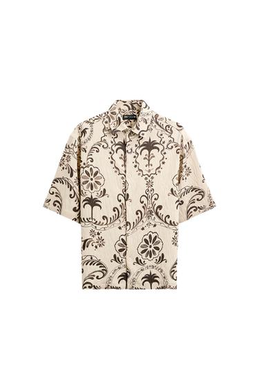 Front view of a beige shirt with floral print and full button closure.