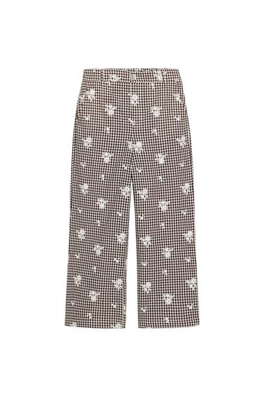 Front view of brown and ecru trousers with a checked and white floral print, straight leg, and elasticated waist.