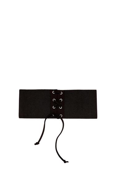 Front view of a wide black belt with laces and metal eyelets.