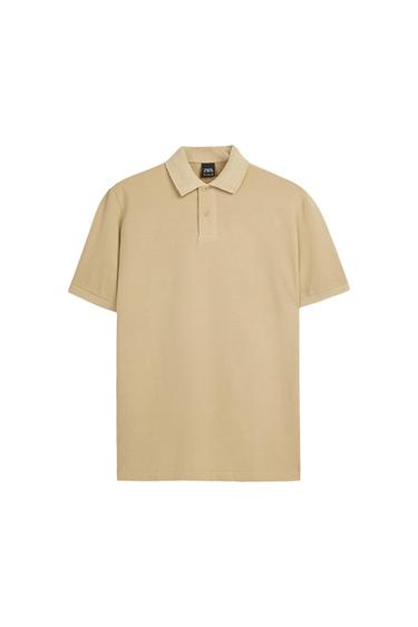 Front view of a beige polo shirt with a classic collar and button fastening.