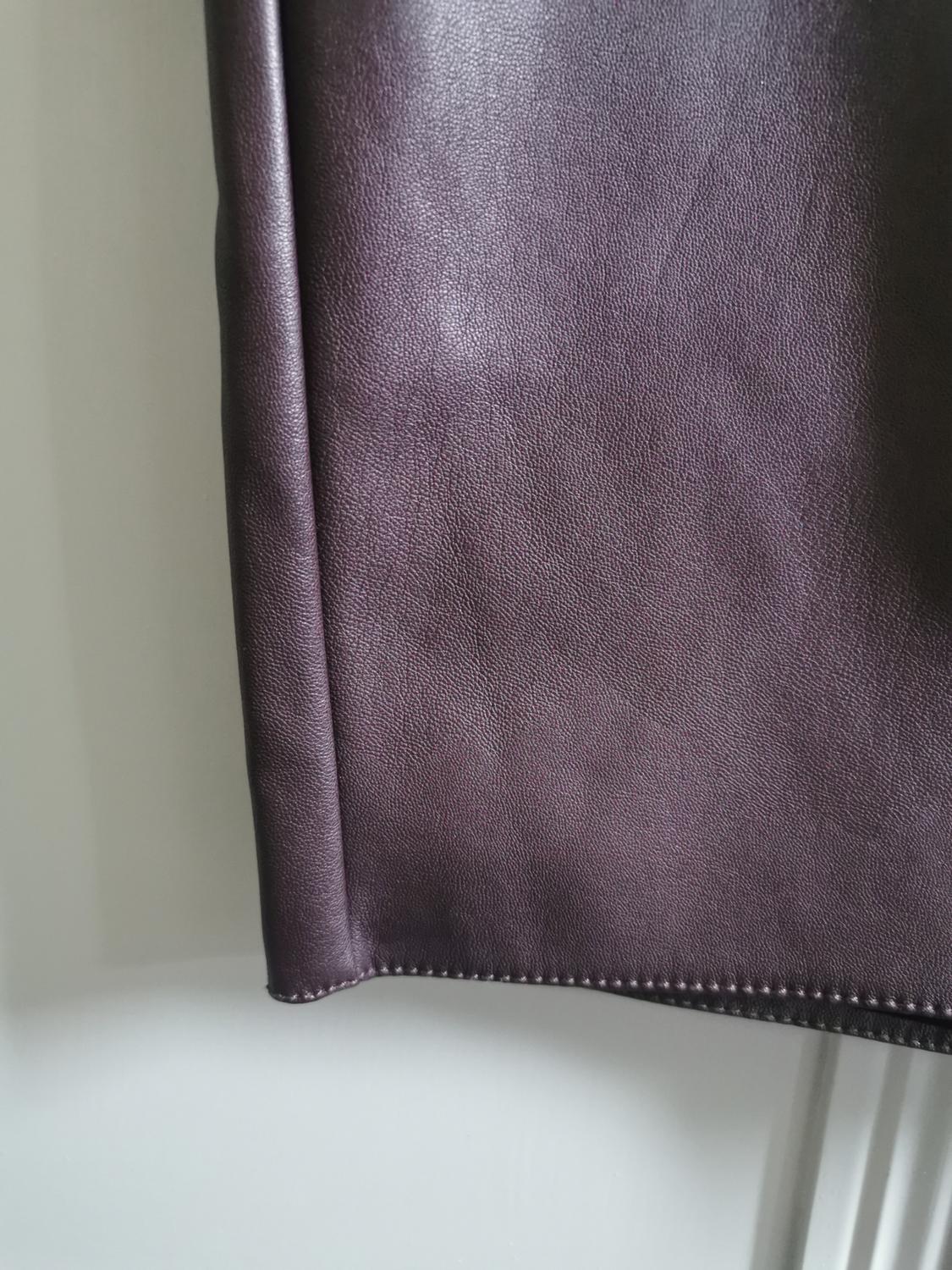 Dark purple garment edge detail with leather texture
